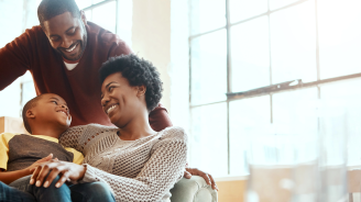 A happy family sitting in the living room of a house