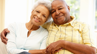 Senior adult couple reading at home.