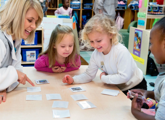 A teacher with a group of pre-k students