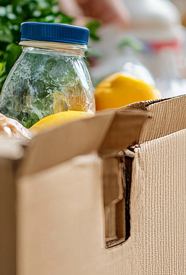 Volunteers distributing food and supplies to the needy at a charitable event on International Day of Charity